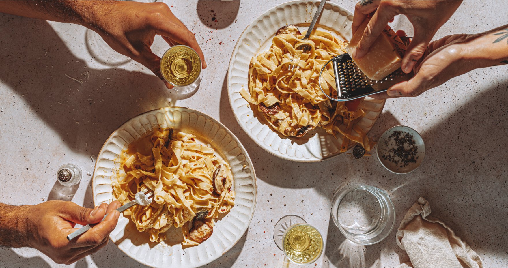 A pair of people enjoying fresh pasta at Saint Bibiana in Savanah